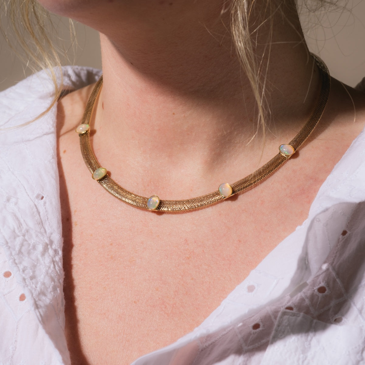 Closeup of model wearing Family Gold Solid Gold Opal Mesh Necklace