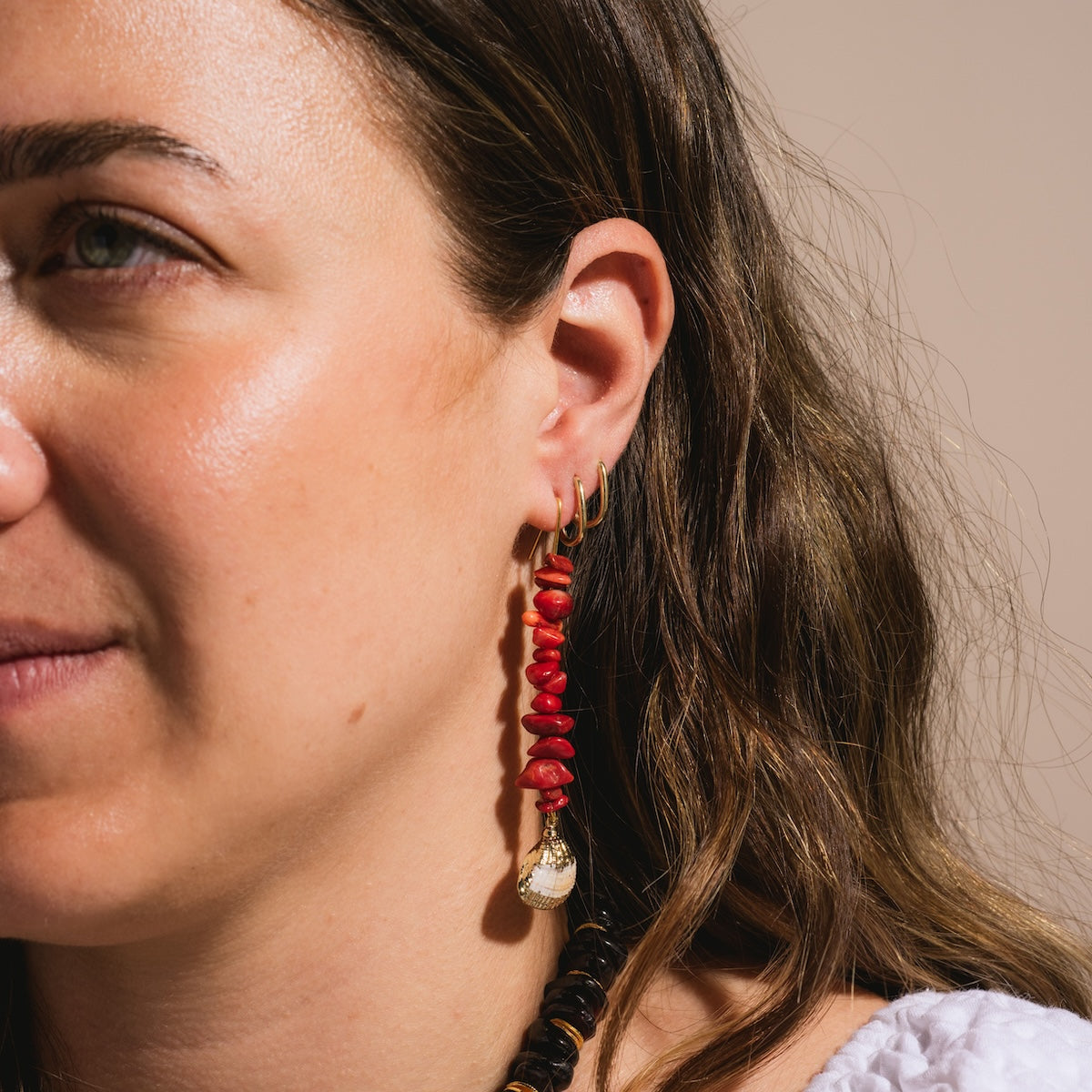 Edith Barbarella red beaded with seashell Paradisco Earrings worn on model's ear