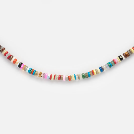 A close-up of the Beaded Gemstone Necklace, featuring small, flat, round multicolored beads arranged in a row against a plain white background—an elegant piece of natural crystal jewelry.