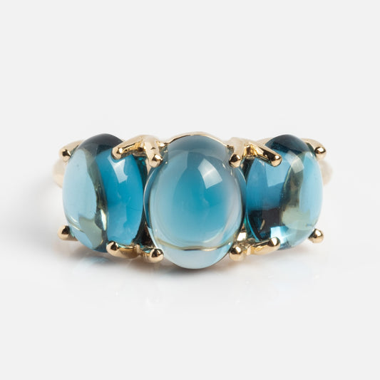 The Sweetest Gumdrop Ring in yellow gold features three large oval blue natural gemstones set side by side with prongs, shown on a white background.