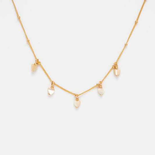 The Heart Bead Choker Sample is a delicate gold-filled necklace with five evenly spaced heart-shaped charms, some featuring shimmering mother of pearl, displayed on a plain white background.