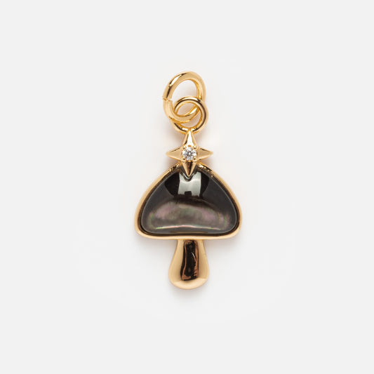 Charms by Elizabeth Stone features a 14k gold plated mushroom-shaped pendant with a dark iridescent cap, topped by a small gold star with a clear gemstone—an enchanting celestial charm on a plain white background.