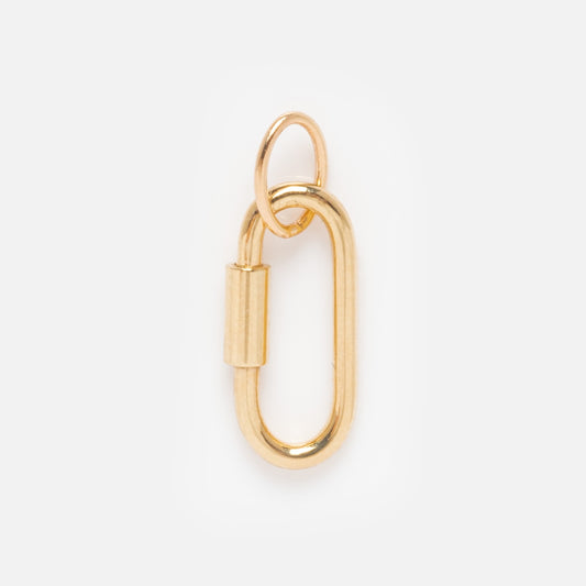The Solid Gold Charm Clip is an oval-shaped gold charm with a clip clasp and a small round loop at the top, ideal for attaching to bracelets. Displayed on a plain white background.