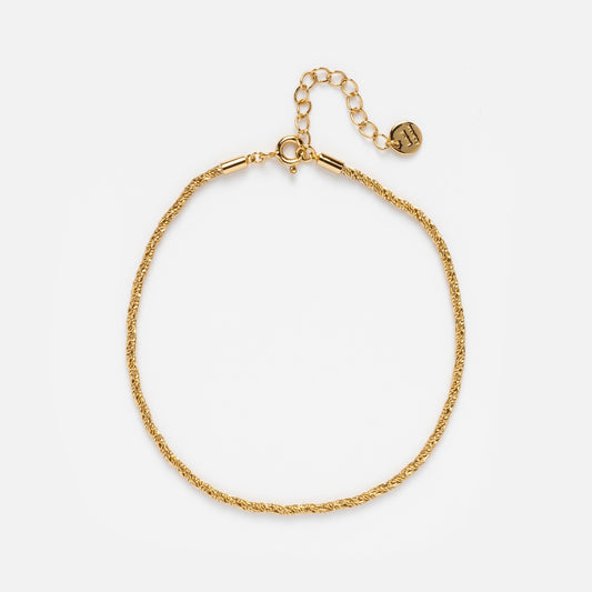 The Essential Gold Chain Anklet Sample is a delicate 14k yellow gold plated anklet with a rope chain, adjustable extender, and small round charm, measuring 8 inches for the perfect fit, displayed on a plain white background.
