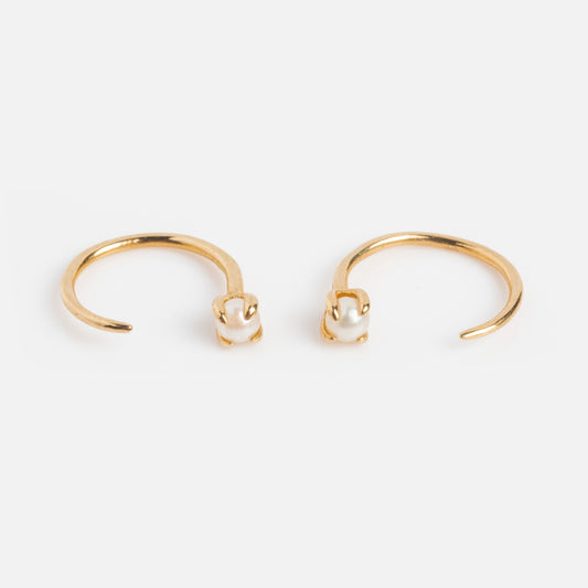 Solid Gold Pearl Ear Huggers featuring a single small white pearl at one end, designed for everyday wear and shown on a plain white background.