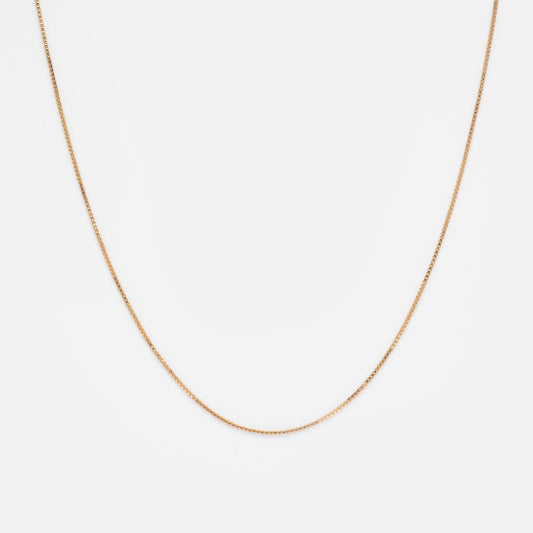 The Solid Gold Box Chain 16 Inch Sample is a thin, delicate necklace crafted from 9k solid gold and shown on a plain white background.