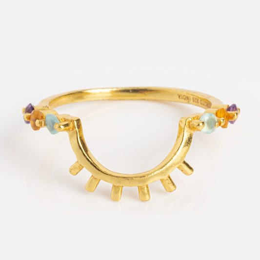 The Sunbeam Ring Sample Size 6 features a unique abstract eye design with amethyst and blue gemstone accents set around an 18k yellow gold plated band and radiating gold prongs at the base.