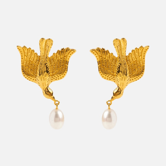 The Sparrow Earrings are gold vermeil bird-shaped earrings with detailed wings, each holding a single white pearl drop in their beaks, shown against a plain white background.