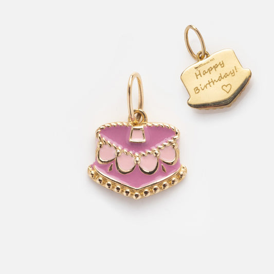 Two Solid Gold Celebration Charms: a 9k yellow gold pink-and-white cake charm and an engraved Happy Birthday! heart charm, both with loop attachments, shown on a white background.