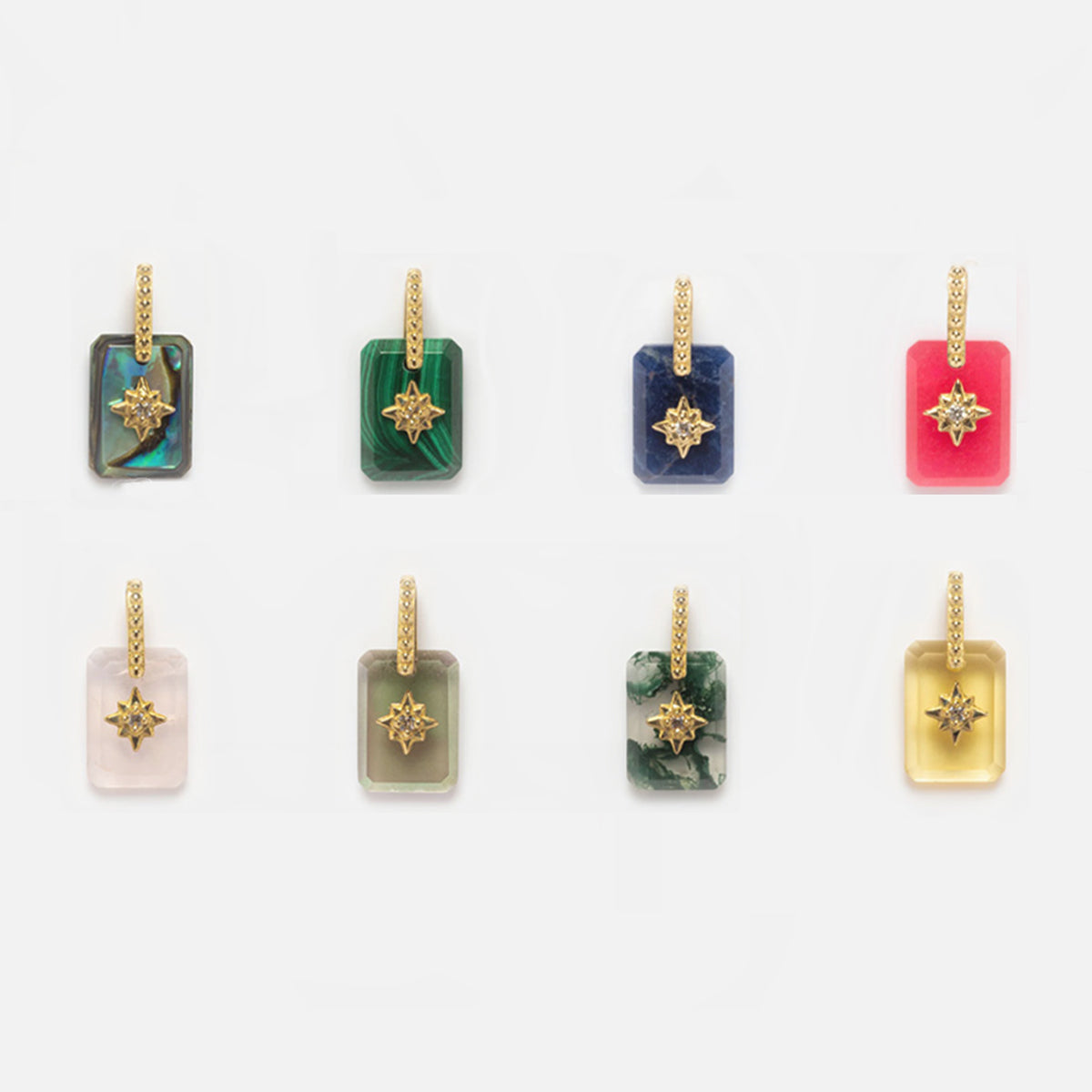 Eight Solid Gold Crystal Amulet Charms for Manifestation, each with a rectangular gemstone pendant in different colors like blue, green, and pink, gold chains, and star accents, displayed in two rows on a white background.