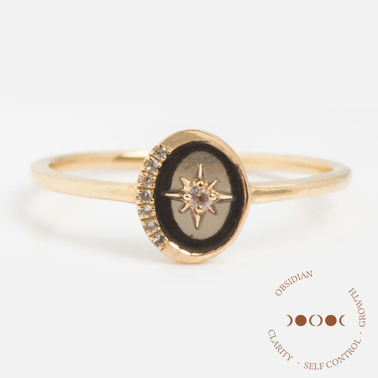 The Solid Gold Crystal Crescent Moon Ring for Manifestation features an oval black stone with a star design, a central gemstone, and clear stone accents—ideal for manifesting clarity, self-control, and growth.