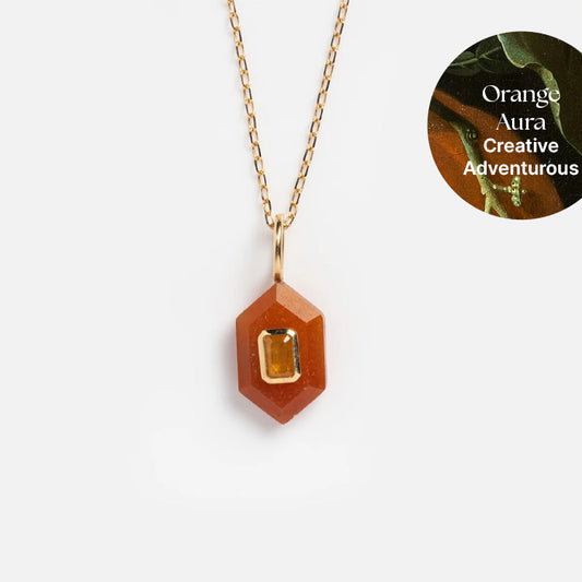The Solid Gold Aura Necklace showcases a hexagonal orange gemstone pendant and a rectangular yellow inset, with Orange Aura Creative Adventurous beside it on a circular background—a vibrant crystal accessory.
