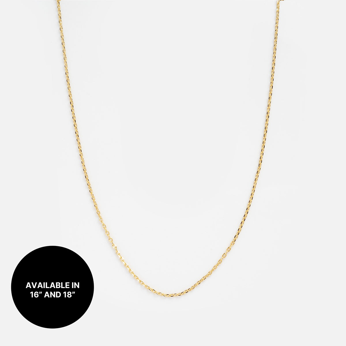 A thin gold plated Chain For Charms is displayed on a white background. A black circle in the lower left corner reads "Available in 16 and 18" in white text—ideal for layering your next necklace stack.