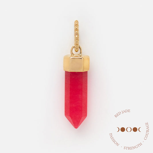 A gold-capped hexagonal red jade pendant hangs from a textured gold loop. Below, text reads: Solid Gold Crystal Charm for Manifestation • Passion • Strength, with a moon phase graphic.