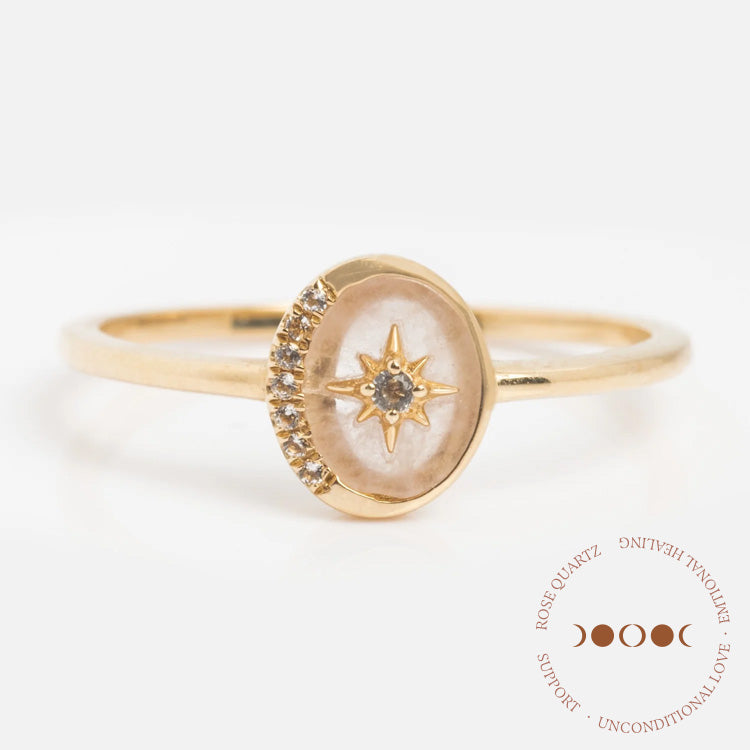 The Solid Gold Crystal Crescent Moon Ring for Manifestation features an oval face with a starburst design and natural crystals, symbolizing Rose Quartz Support, Emotional Healing, and Unconditional Love.