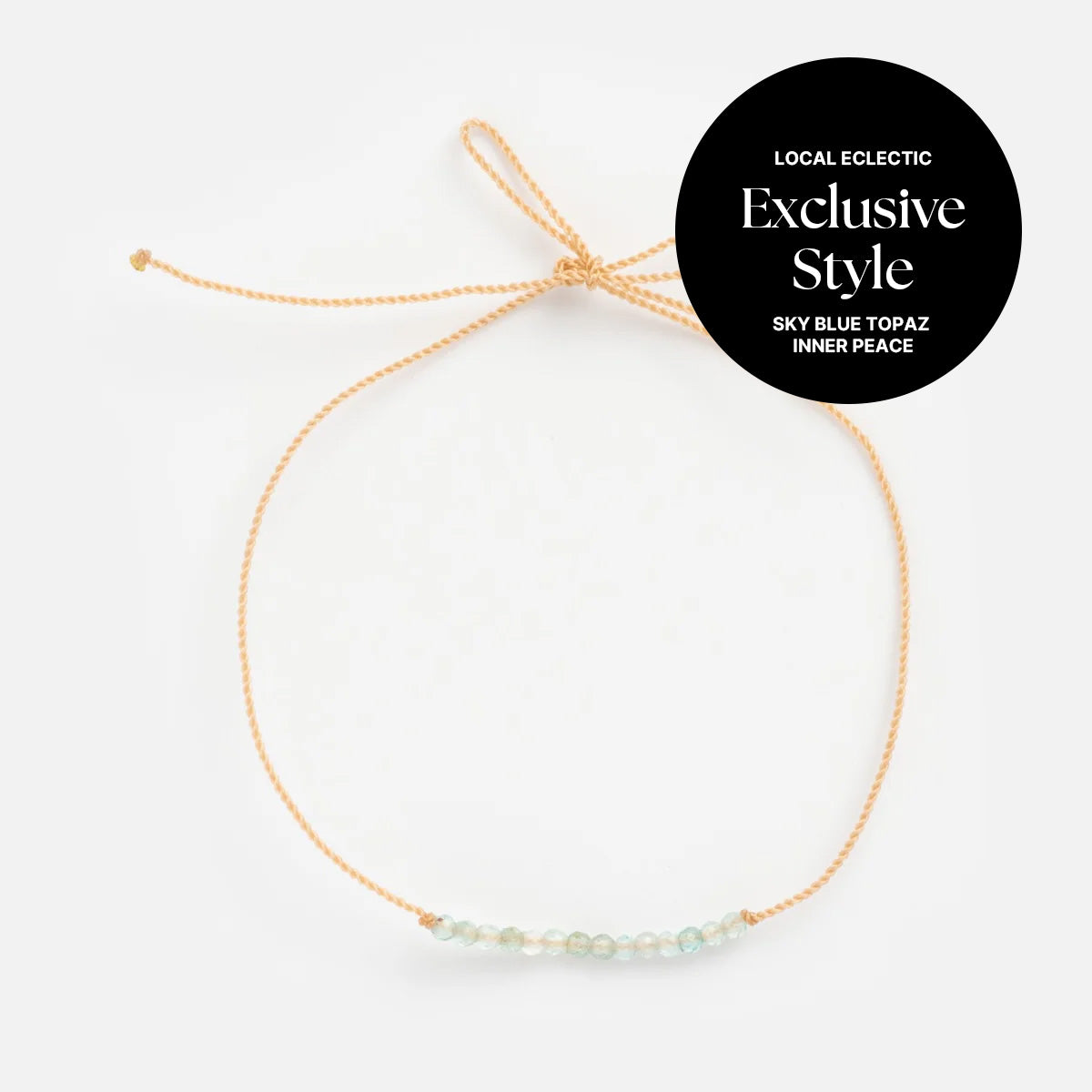 Anokhi Green x Local Eclectic Gemstone Wish Bracelet with beige adjustable cord and sky blue topaz beads, labeled "Exclusive Style, Sky Blue Topaz, Inner Peace, Local Eclectic," shown on a white background.