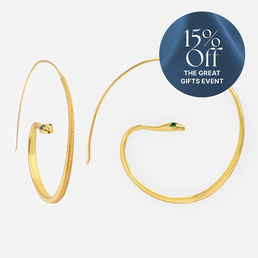 A pair of Snake Hoop Earrings, shaped like snakes with green eyes and crafted in 18k yellow gold plated metal, are displayed on a white background. A blue circle in the upper right reads "15% Off THE GREAT GIFTS EVENT.