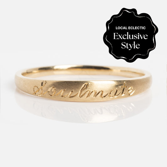 The Soulmate Band is a gold ring with a 1.4 mm band, engraved with "Soulmate" in cursive. A black badge at the top right says "Local Eclectic Exclusive Style" on a plain white background.