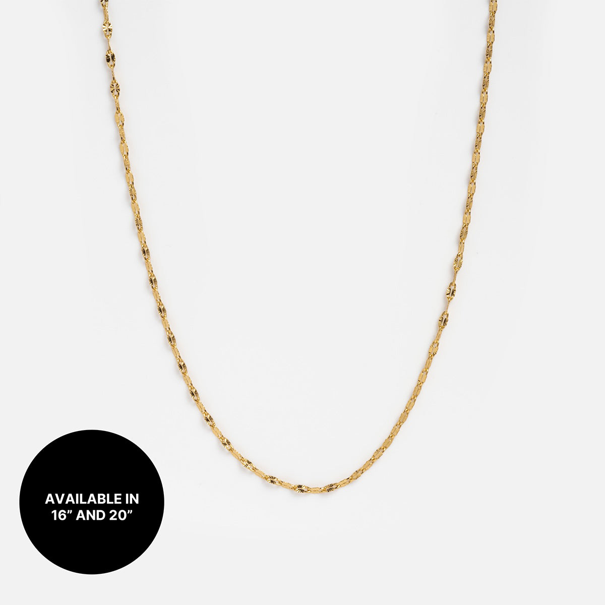 Chain For Charms: A delicate gold plated chain necklace shown on a white background, featuring a black circle in the corner with "Available in 16 and 20." Ideal for chic layering or wearing solo for subtle elegance.