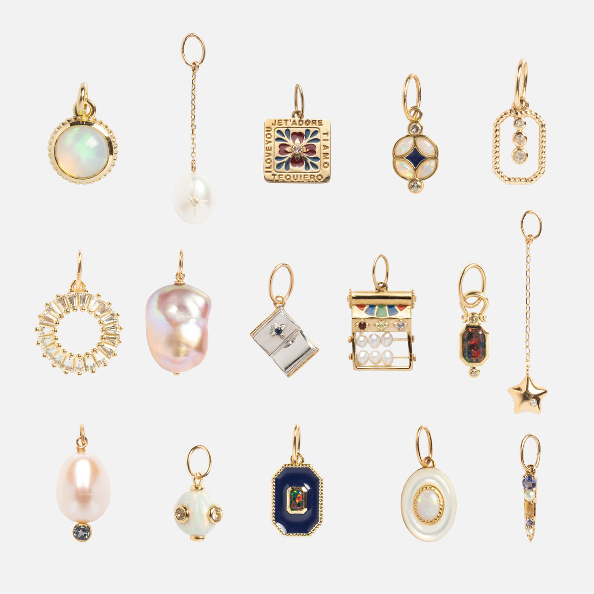 A set of fifteen Solid Gold Statement Charms, each featuring unique shapes with gemstones, pearls, and intricate designs, neatly arranged in a grid on a white background.