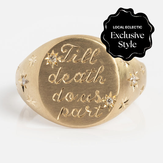 The Till Death Do Us Part Signet with Diamonds is a gold ring engraved with "Till death do us part," adorned with star-shaped diamond accents. A black label marks it as a Local Eclectic Exclusive Style.