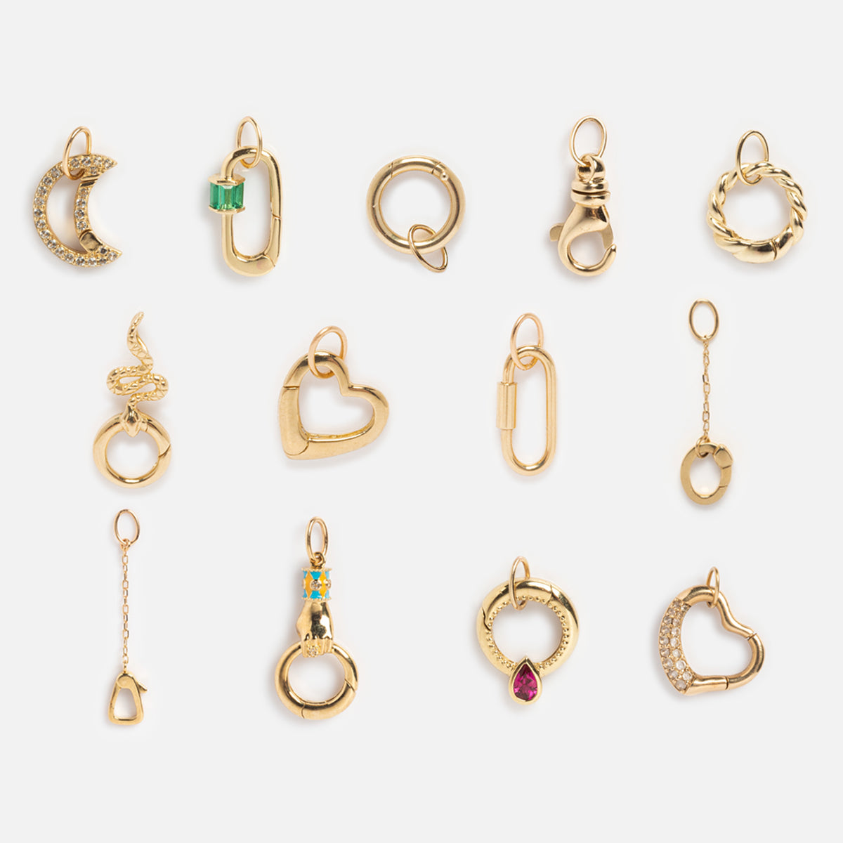 A set of 14 small gold charms and pendants—crescent moon, hearts, circles, and a snake—displayed in rows on white. Perfect for your personalized necklace with the Solid Gold Charm Clip.