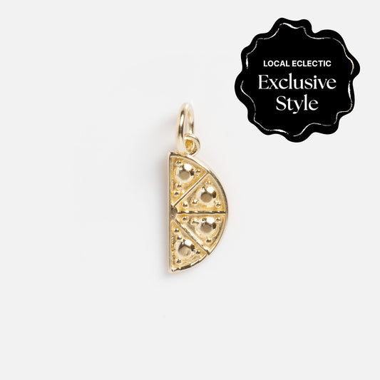 Gold pizza slice charm with heart-shaped cutouts on a white background. A black label reads “Local Eclectic Exclusive Style.” Part of the Zahava x Local Eclectic Globetrotter Charms, ideal for travel-inspired jewelry lovers.
