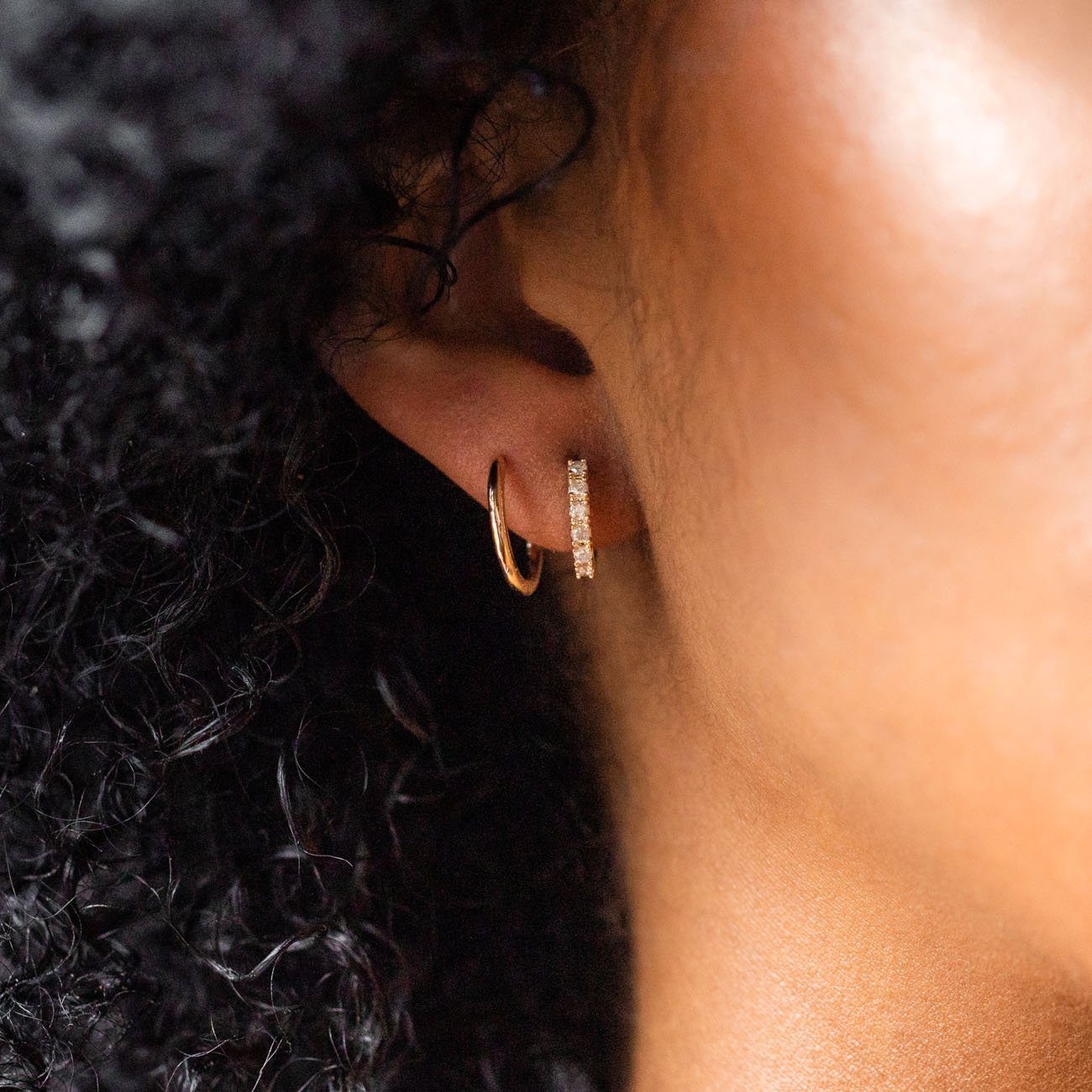 Local Eclectic Diamond and Gold Huggie Hoop Earrings on Ear