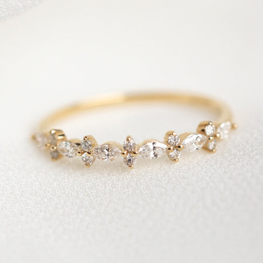 The 14k Luxe Diamond Celebration Band Sample Size 7 features alternating marquise and round-cut diamonds in a floral design, elegantly displayed on a soft, light-colored fabric background.