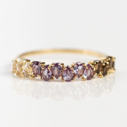 The Solid Gold Ombre Birthstone Ring June Sample Size 4 is a 9k yellow gold ring with marquise-cut natural gems in purple, brown, and champagne hues set closely across the band.