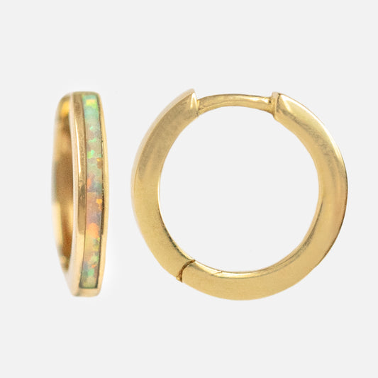 The Solid Gold Opal Inlay Huggie Hoops Sample features one 9k yellow gold hoop with a synthetic opal inlay and another with a plain gold finish, both displayed against a white background.