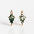 The Solid Gold Aquatic Agate Elements Kite Studs feature diamond-shaped green stones with moss-like patterns and small round white sapphires, shown on a white background.