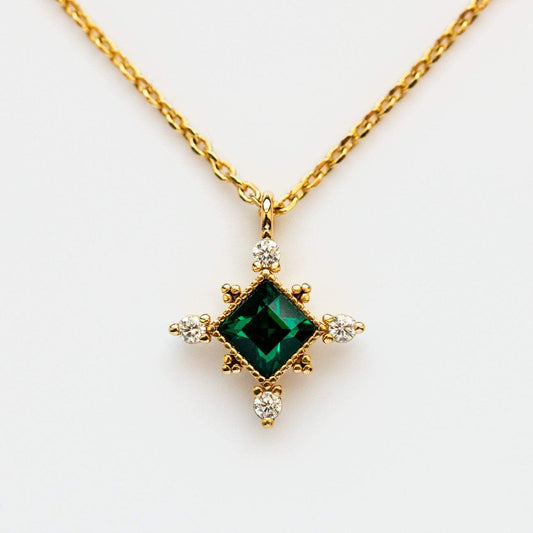 The Emerald Sierra Necklace from Lover's Tempo is vintage inspired and featured Emerald Swarovski crystal with a yellow gold chain.. 