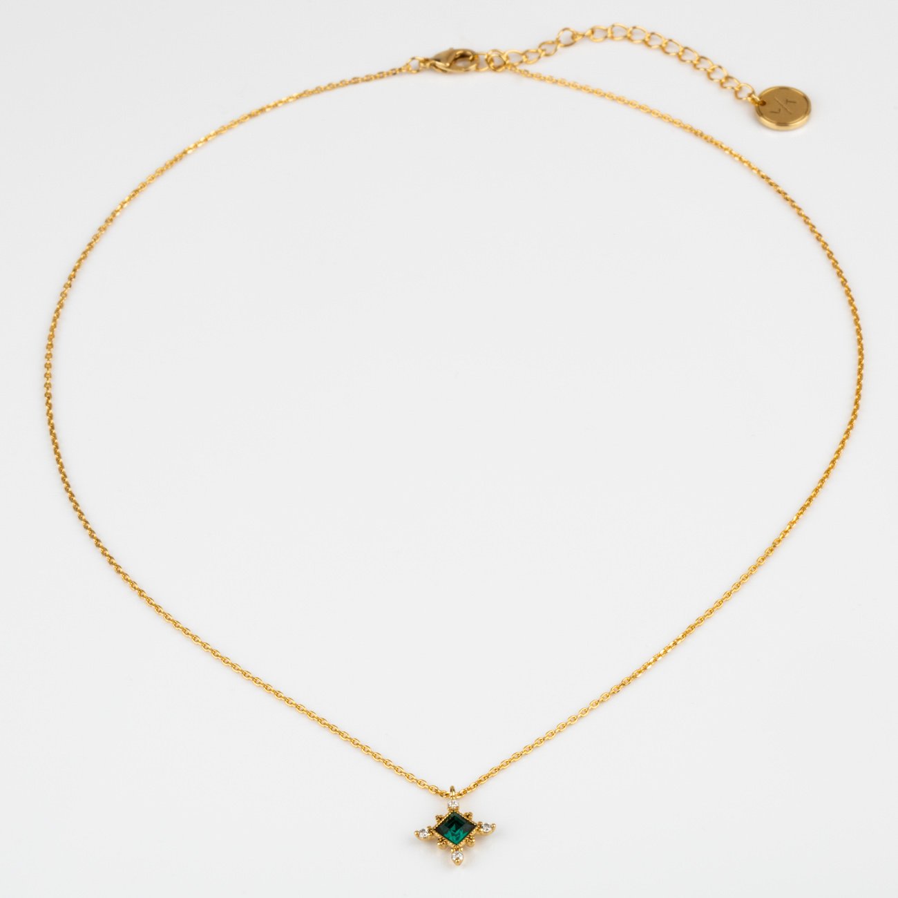 The Emerald Sierra Necklace from Lover's Tempo is vintage inspired and featured Emerald Swarovski crystal with a yellow gold chain.