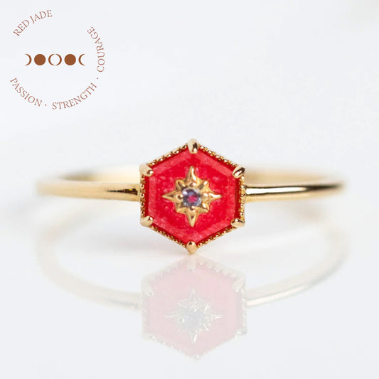 A Solid Gold Crystal Ring for Manifestation in size 8 featuring a hexagonal red jade stone and central diamond, shown on white. Text: “RED JADE, PASSION • STRENGTH • COURAGE” with a crescent moon design.